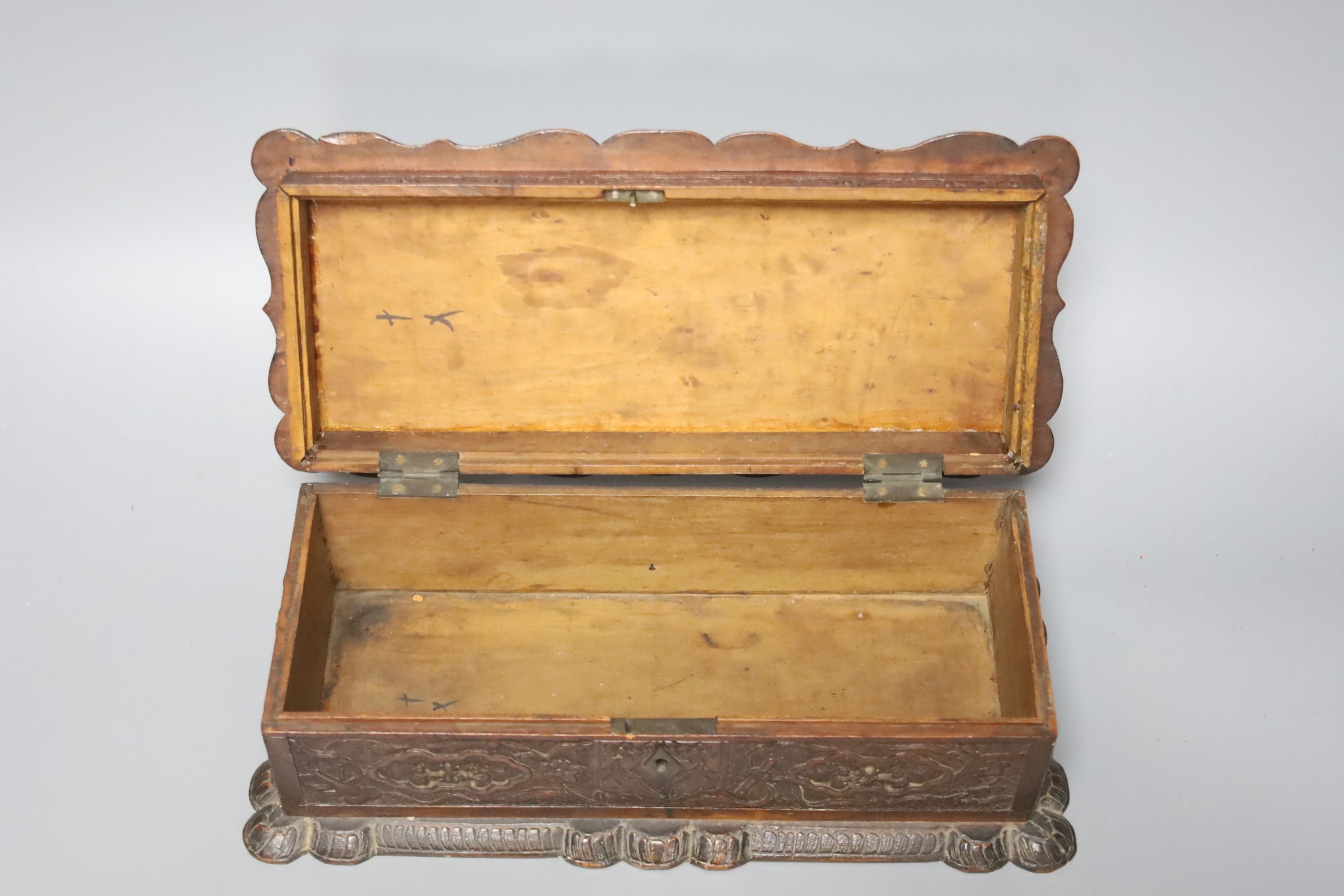 Two 19th century Chinese carved sandalwood boxes, together with a similar puzzle box, length 27cm